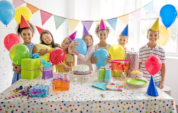 Group of adorable kids having fun at birthday party
