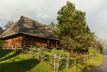 Fototapeta na wymiar old wooden houses with thatched roof, Ancient traditional ukrainian rural cottage with a straw roof