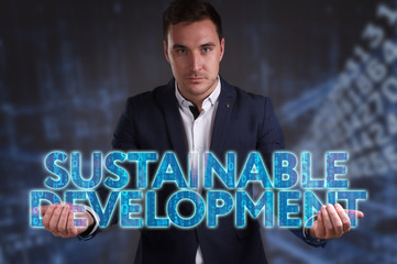 The concept of business, technology, the Internet and the network. Young businessman showing inscription: Sustainable development