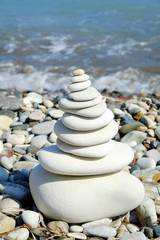 Fototapeta na wymiar Seashore background with stone construction concept of balance and harmony