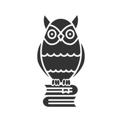 Owl on books stack glyph icon