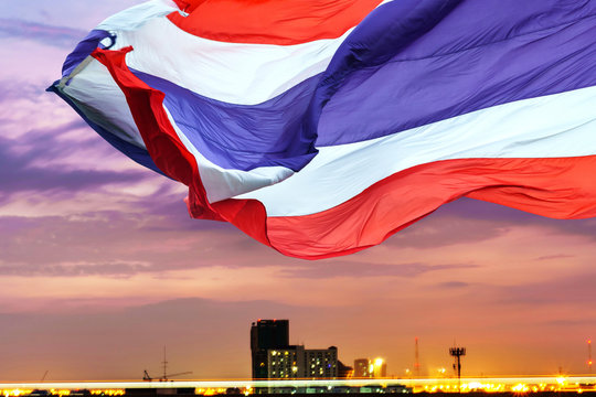 Waving flag of Thailand on twilight sky background