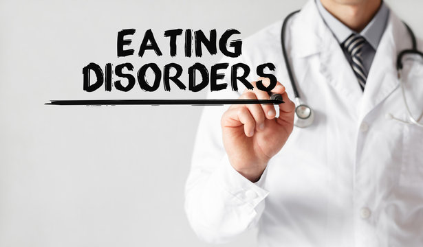 Doctor writing word Eating Disorders with marker, Medical concept