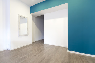 Empty room with walls and wooden parquet floor and door
