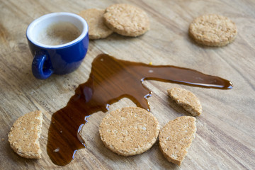 biscuits and espresso coffee spilled on the table