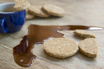 biscuits and espresso coffee spilled on the table