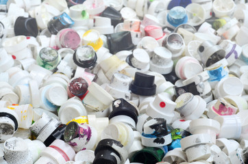 A pattern of many used and soiled nozzles from spray cans with aerosol paint. Background texture of...