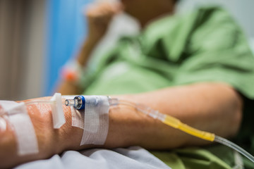 Hand of a patient in Hospital ward, Patient Health Care concept.