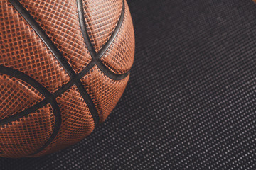 Old basketball ball on black background copy space