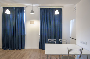 Kitchen interior with fridge and table, new modern dining room interior