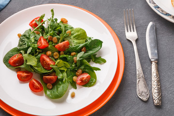 Eating healthy food on gray background.