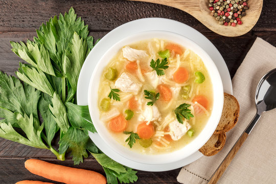 Chicken soup with noodles, closeup photo with copyspace