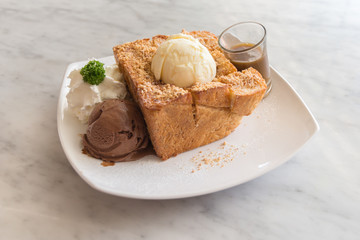 Honey toast with vanilla, chocolate ice-cream and whipped cream.