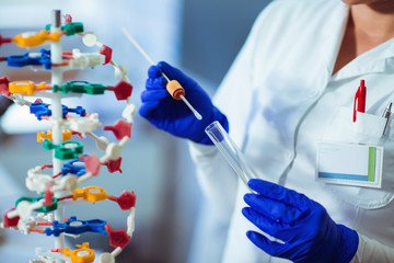 Woman collects forensic DNA sample stick in laboratory