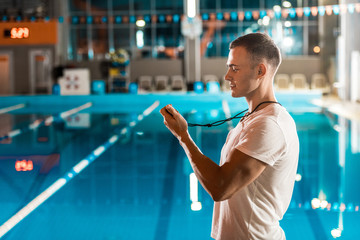 swim coach with stopwatch - Powered by Adobe