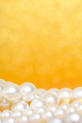 Pile of pearls on golden christmas background