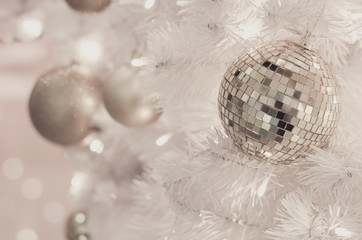 White Christmas decoration with balls on fir branches with blurred background