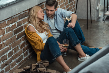 couple drinking wine on floor