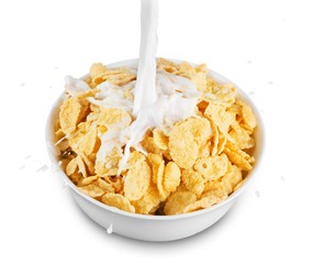 pouring milk into bowl of corn flakes, top view