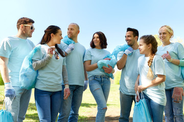 group of volunteers with garbage bags in park