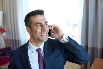 businessman calling on smartphone at hotel room