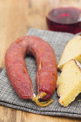 smoked sausage chorizo with corn bread on wooden background