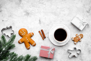 Obraz na płótnie Canvas Coffee with gingebread cookies and gifts in christmas evening. Grey stone background top view copyspace