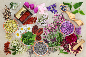 Fototapeta na wymiar Herbs and flowers used in alternative herbal medicine on natural hemp paper background. Top view.