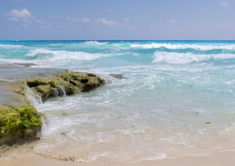 Coastline and beaches on the Caribbean ocean. Waves hitting the cliffs on a sunny day.
