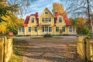Picture of red wooden scandinavian style house at the lake during autumn