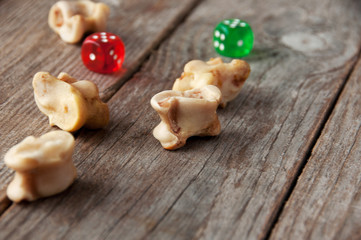 Real dice. Knuckle bones and gaming pieces. Ancient game with lamb bones .
