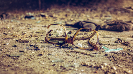 Frame of glasses forgotten in time in the hall of an abandoned factory