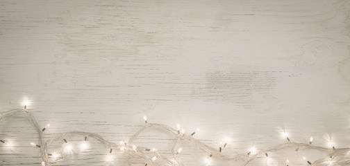 Chrsitmas ornamet led string lights on vintage wooden background