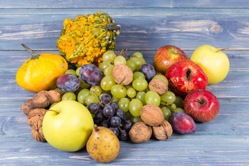 Bunch of autumn fruits on wooden background