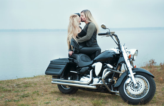 Couple on a bike in a leather jackets 