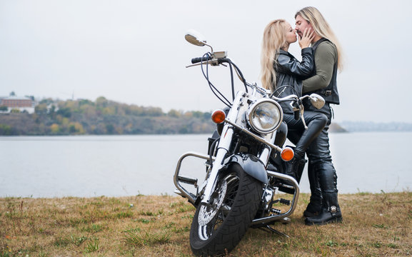 Couple on a bike in a leather jackets 
