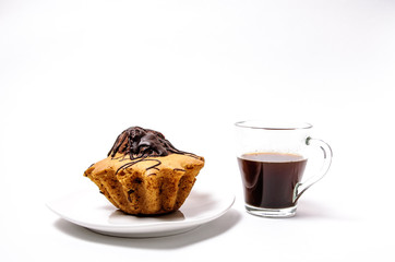 Fresh and flavored cupcake on a white plate with black coffee on a white background