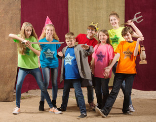 Young actors pose together with sword