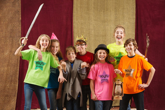 Young actors pose with costume pieces