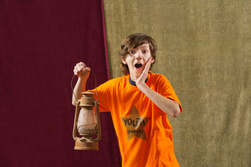Surprised actor holds lamp