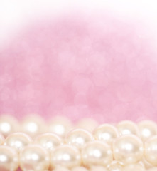 Pile of pearls on pink festive background
