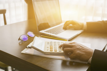 Hand man doing finances and calculate on desk about cost at home office.businessman working with...