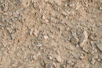 Texture of the soil after a landslide, crushed stone covered with dried mud