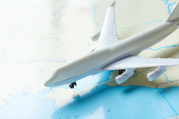 miniature of a passenger aircraft flying on a map