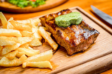 Beef steak with pepper sauce and Grilled vegetables on cutting board  dark wooden background