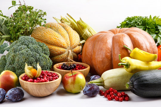 Autumn harvest vegetables, fruits, berries and herbs on white background.