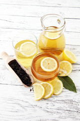 Hot tea in a transparent cup. Tea with lemon fruits. Warming drink