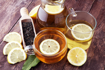 Hot tea in a transparent cup. Tea with lemon fruits. Warming drink
