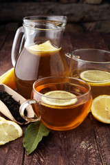 Hot tea in a transparent cup. Tea with lemon fruits. Warming drink