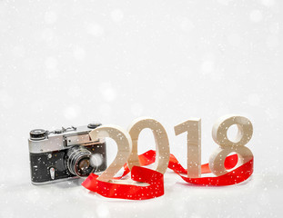 Figures 2018 carved from wood with a vintage camera. Concept of a New Year's postcard, poster....